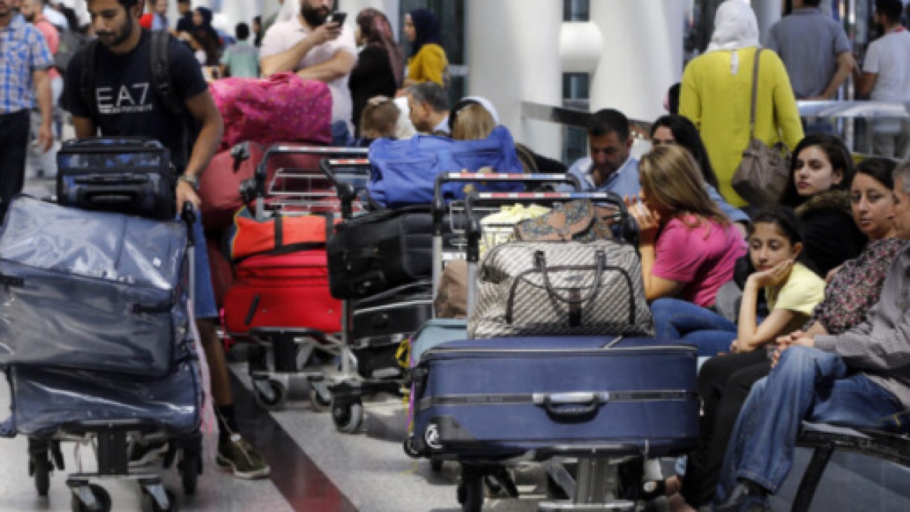 Travelers sit next to their luggage at the departure terminal of the Rafik Hariri International Airport in Beirut, Lebanon, Tuesday, Aug. 20, 2019. Lebanese Prime Minister Saad Hariri inaugurated new measures at the country's main international airport that aim to end crowding at the departure lounge. Passengers will check in their luggage that will later be scanned by the sophisticated scanners. (AP Photo/Bilal Hussein)/OTK/19232458530751//1908201510